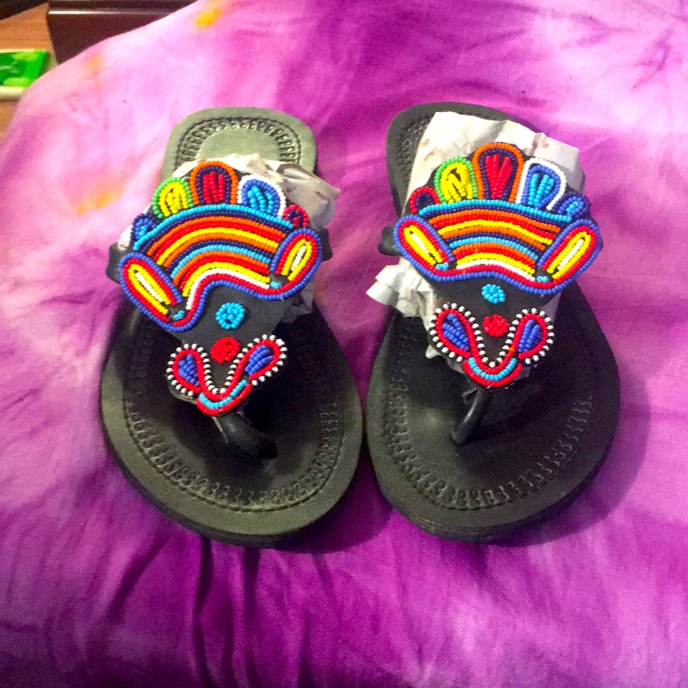 Hand beaded leather flip flops.